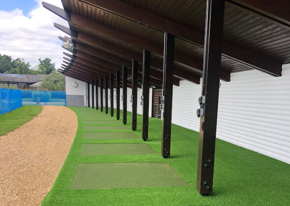 Charlotte Covered outdoor tee line with light green synthetic grass boxes inside a dark green synthetic grass strip